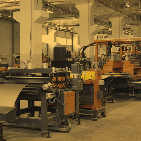 Etcoma supermarket shelving production unit in an industrial setting, featuring precision rollers, automated components, and conveyor systems for high-efficiency manufacturing